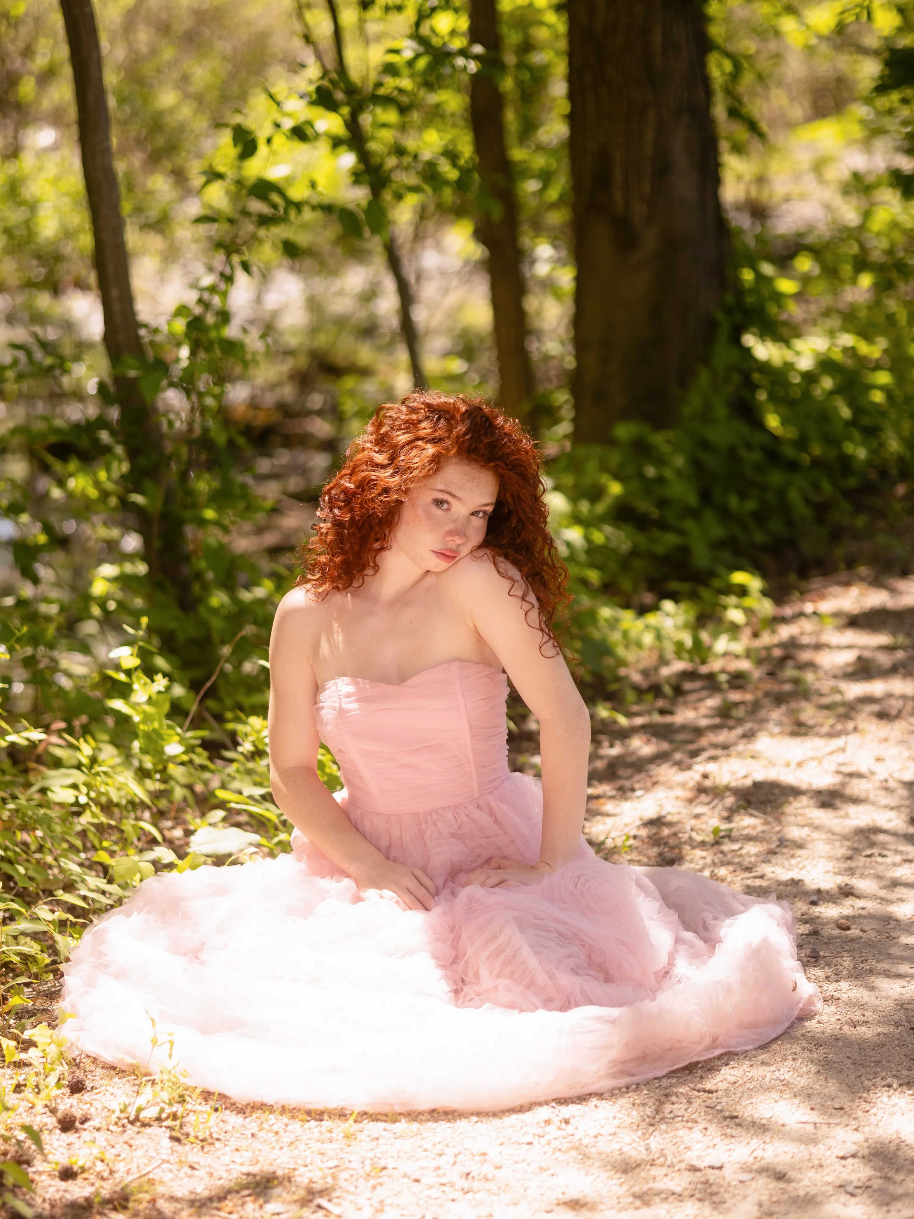 Livia Paige in a pink tulle princess gown in a forest