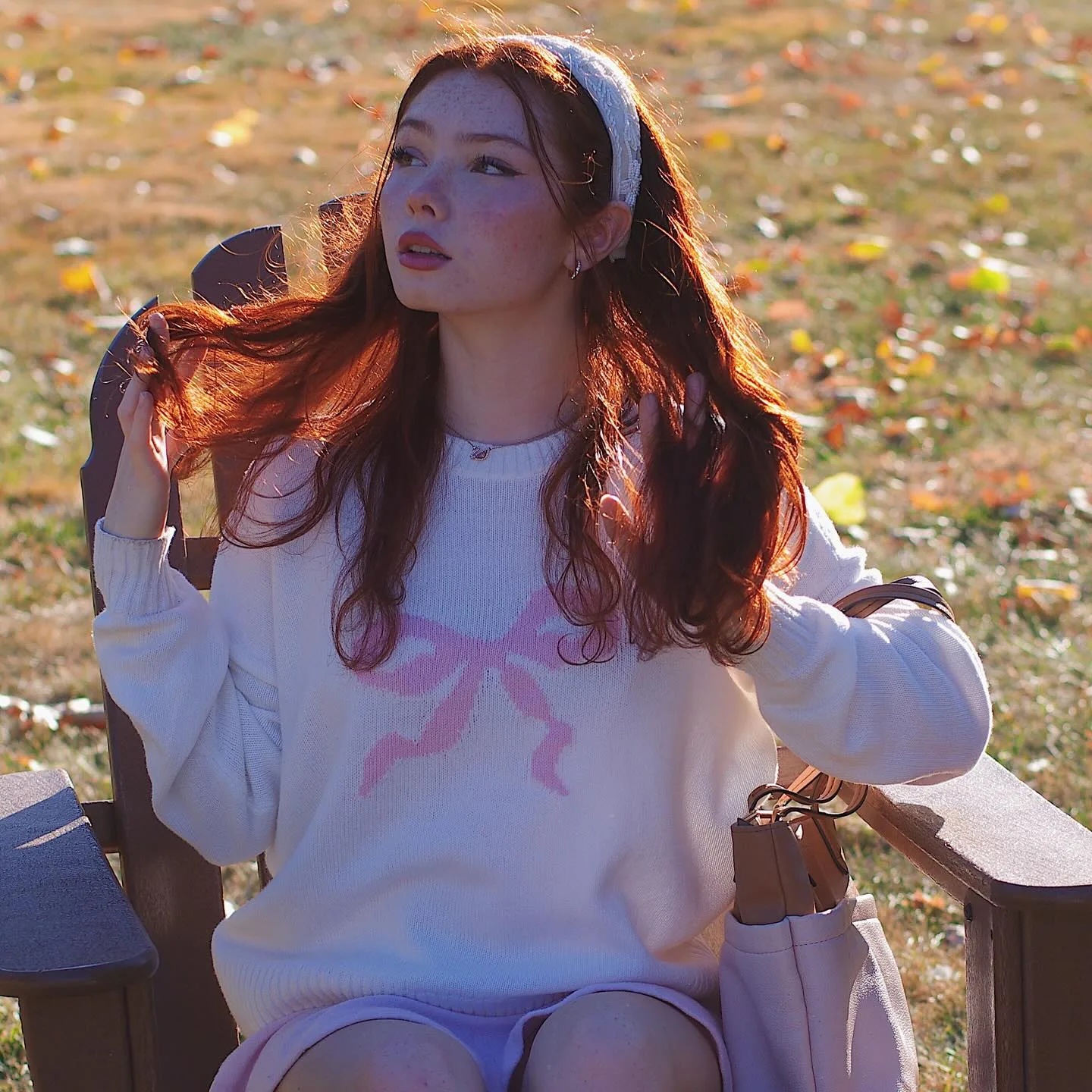 Livia Paige in a girly autumn outfit in the park