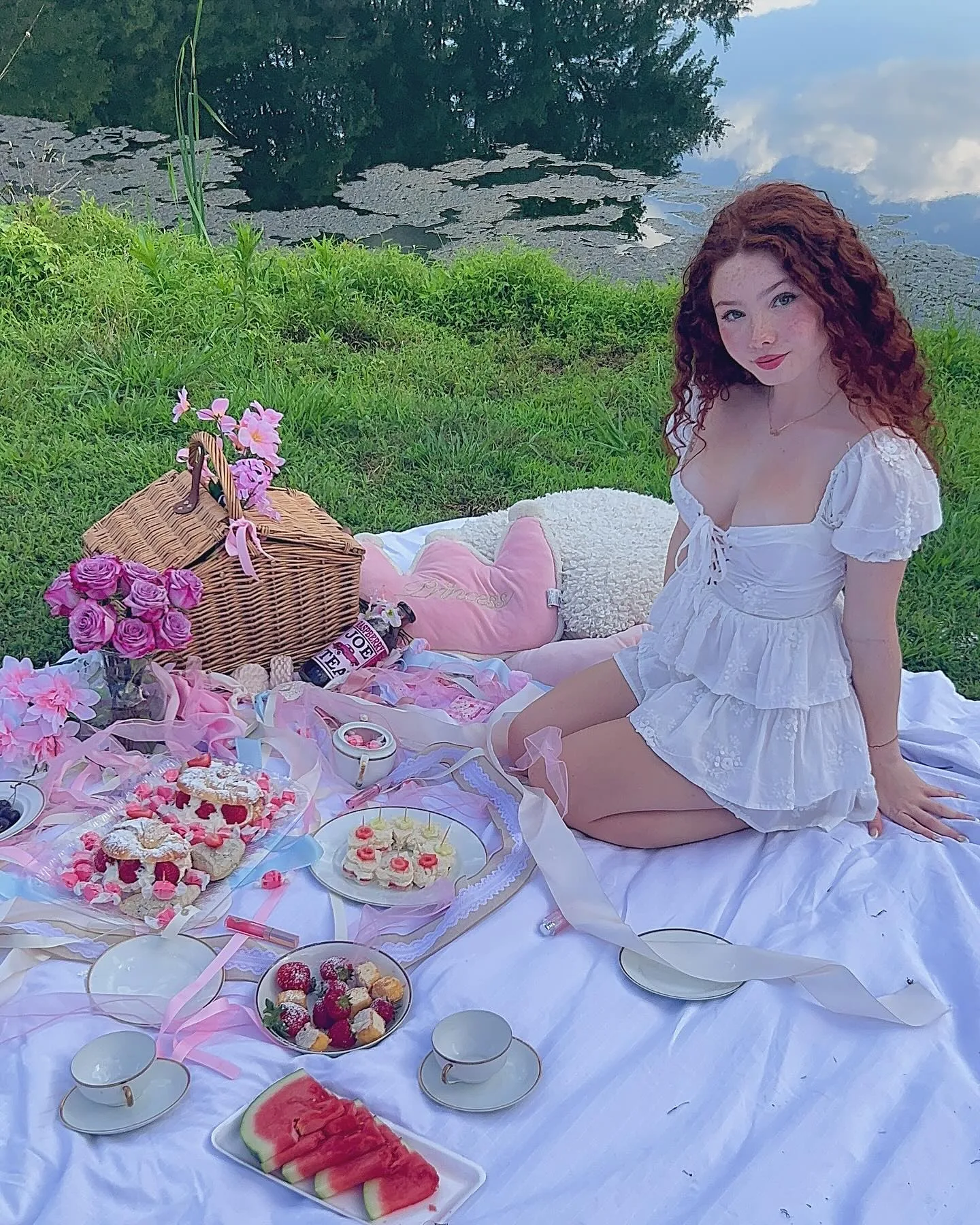 Livia Paige at a strawberry summer picnic in a white dress